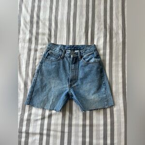 light wash jorts with frayed ends